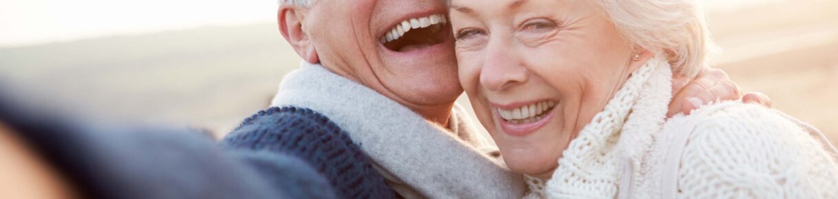 Senior Couple Standing On Beach Taking Selfie Senior Couple Standing On Beach Taking Selfie Smiling